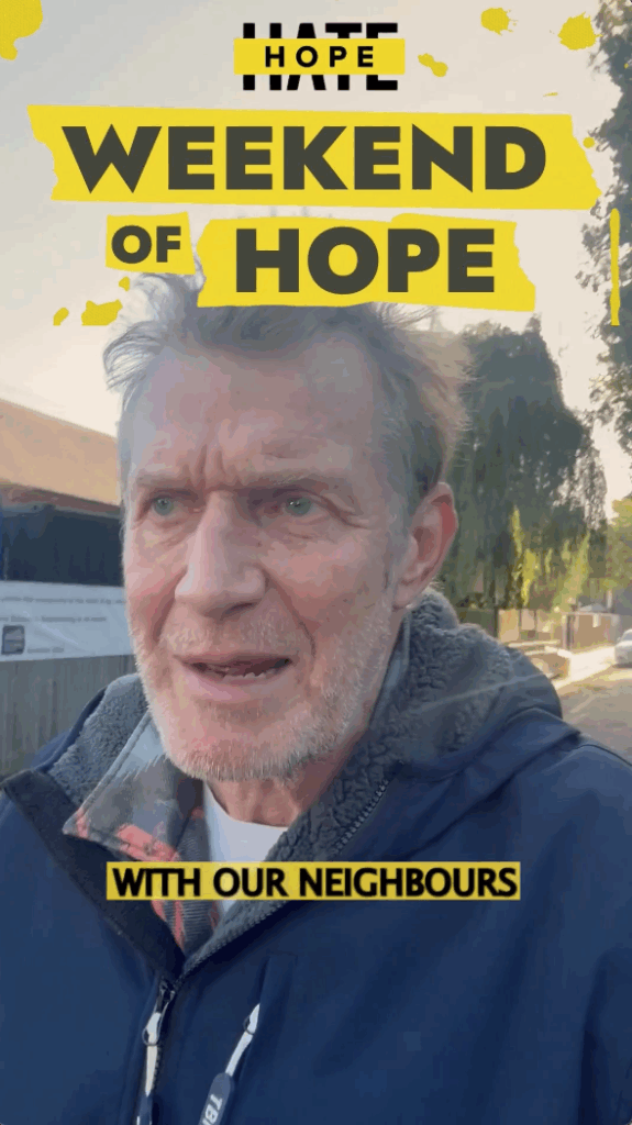 A screenshot of a video where Jason Flemyng is walking down a residential street, filming himself speaking to the camera. Bold yellow text overlays read "Weekend of Hope" and "with our neighbours" is in the captions, in black lettering.