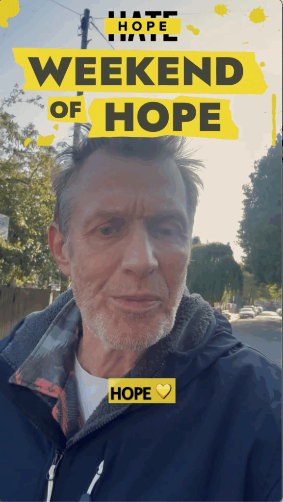 A screenshot of a video where Jason Flemyng is walking down a residential street, filming himself speaking to the camera. Bold yellow text overlays read "Weekend of Hope" and "hope" is in the captions, in black lettering.