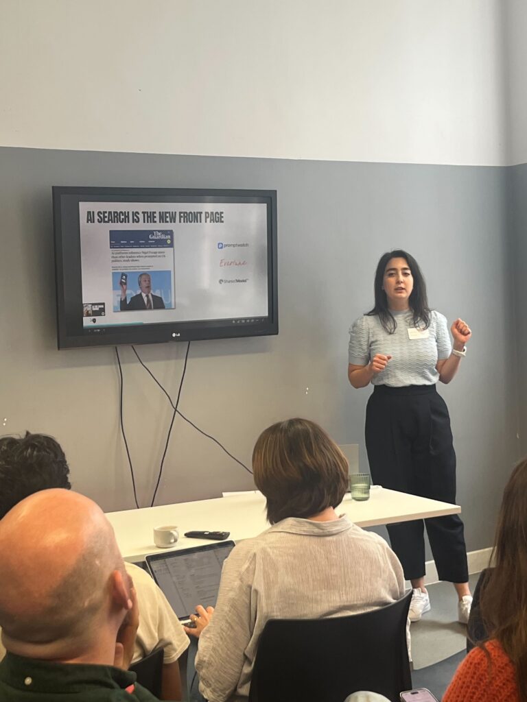 Speaker presenting a session on AI search, media influence and online climate campaigning tactics to an audience seated at a workshop